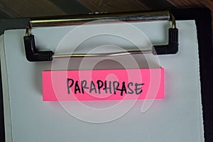 Paraphrase write on sticky notes isolated on Wooden Table