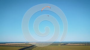 Paraplane, paraglider in the air aerial shot. Extreme life. A man is flying on a paraglider.