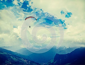 Paraplane in sky above mountains