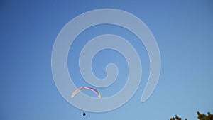 Paraplaner flies in blue sky