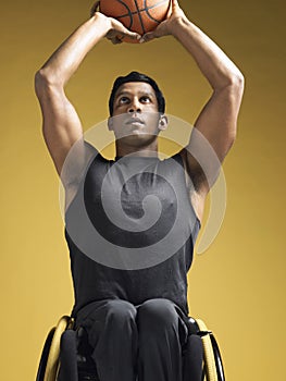 Paraplegic Athlete In Wheelchair Shooting Basketball photo
