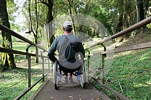 Paraplegic using ramp made for wheelchair users in  park photo