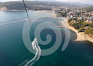 Parasailing above the water near the coast of the city of Dzhubga