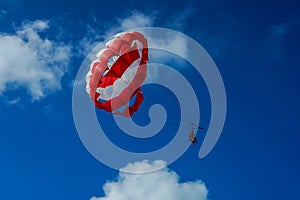 Parasailing in a blue sky in Cancun, Mexico