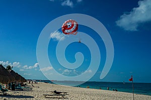 Parasailing in a blue sky in Cancun, Mexico