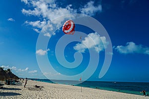 Parasailing in a blue sky in Cancun, Mexico