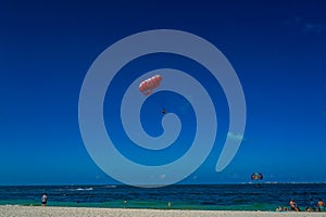 Parasailing in a blue sky in Cancun, Mexico