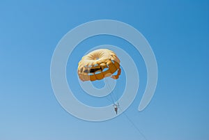 Parasailing in a blue sky near sea beach