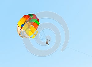 Parasailing boat towing the parachuters, extremal beach amusement