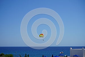 Parasailing in the Mediterranean. Parasailing is a recreational kiting activity where a person is towed behind a vehicle. Rhodes