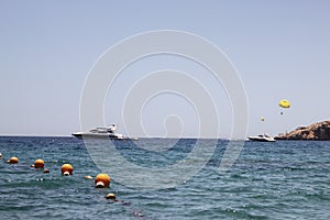 Parasailing with one yellow parachute