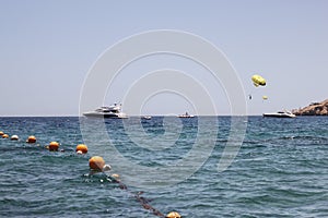 Parasailing with one yellow parachute