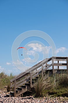 Parasailing over Las Flores beach surrounded by growing trees and grass photo