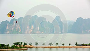 parasailing over limestone mountain islands,Halong Bay,Vietnam