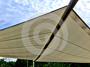 parasol, awning, folding tarpaulin against the sun is rolled up into a roll