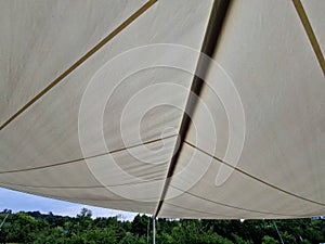 parasol, awning, folding tarpaulin against the sun is rolled up into a roll