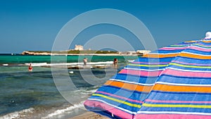 Parasol in the beach of Portopalo (southern Sicily) photo