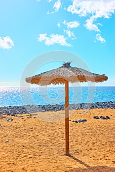 Parasol on sandy beach photo