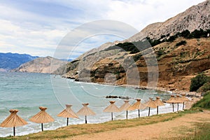 Parasols on the beach , Baska, island Krk, Croatia