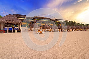 Parasols on the beach of Caribbean Sea at sunrise