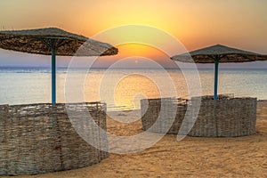 Parasols on the beach of Red Sea in Hurghada at sunrise