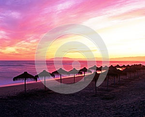 Parasols on beach, Torrox Costa, Spain.