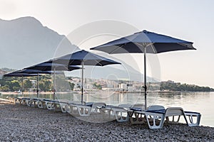 Parasols and deck chairs on the beach in Baska Voda