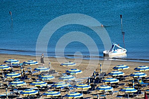 parasols of diiferent colors on the beech of Gabicce Mare Italy