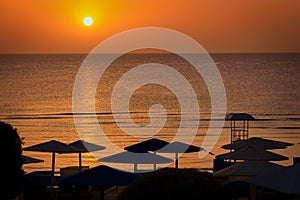 Parasols by the Red Sea at sunrise, Egypt