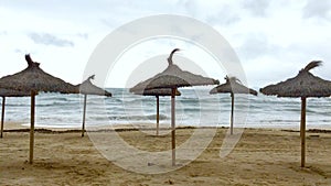 Parasols on sandy beach after the tourist season