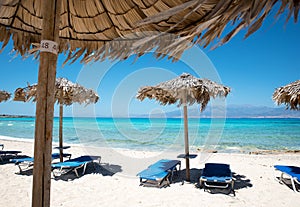 Parasols and sun loungers on beach