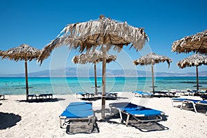 Parasols and sun loungers on beach