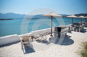 Parasols and sun loungers on beach