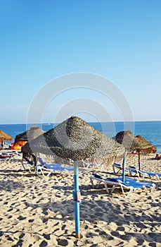 Parasols and sun loungers on the beach