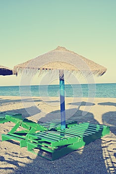 Parasols and sun loungers on the beach, retro/vintage