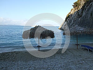 Parasols at Xigia Beach. The water on this beach contains sulfur and collagen