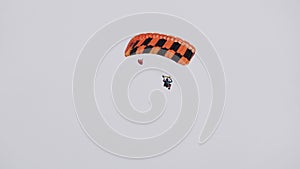 Paratrooper controll parachute. Skydiver slow landing. Parachutist flying sky.