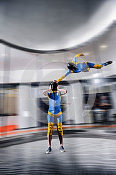 Paratrooper. Speedfly start. Fly men is a pilot of his body in air. Parachutist in blue suit. Air sport as a way of life