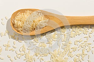 Parboiled Chinese Rice seed. Healthy grains on a wooden spoon. W photo