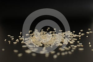 Parboiled long-grain rice on a black background. Stock photo of Close-up side views rice grain