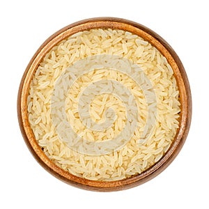 Parboiled long grain rice, converted rice in wooden bowl photo