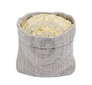 Parboiled rice in burlap bag isolated on white