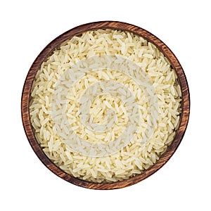 Parboiled rice in a wooden bowl isolated on a white background. Top view