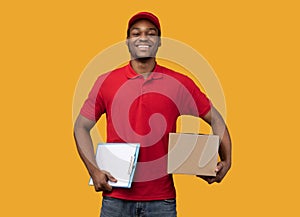 African american delivery man holding clipboard and box