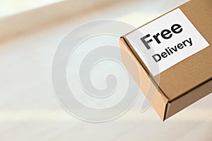 Parcel with sticker Free Delivery, space for text. Courier service