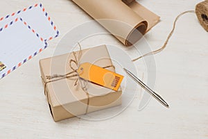 Parcel tied with string with address orange label attached