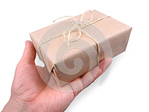 Parcel wrapped in brown paper in man's hand