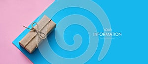 Parcel wrapped in craft paper and tie hemp string. Pink and blue backgrounds. Arrow to the left. Web article template. Long header