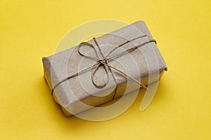 Parcel wrapping in brown craft paper and tie hemp string. Package. Delivery service. Online shopping. Your purchase.