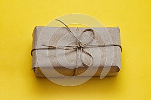 Parcel wrapping in brown craft paper and tie hemp string. Package. Delivery service. Online shopping. Your purchase.